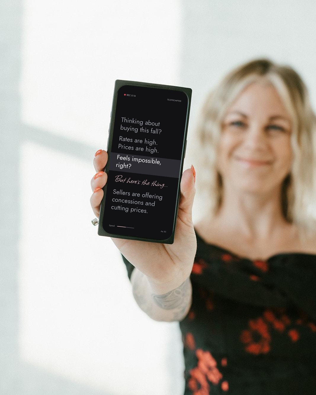 Brooke holding a phone displaying a market script in her teleprompter